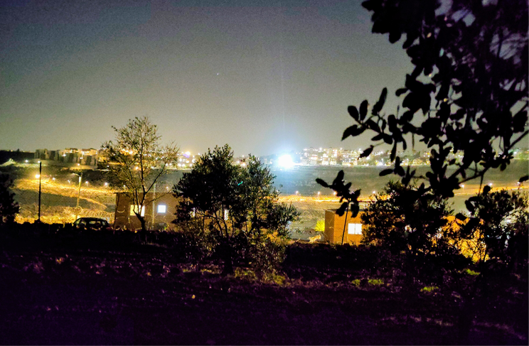 Searchlights at night near the Tent of Nations farm