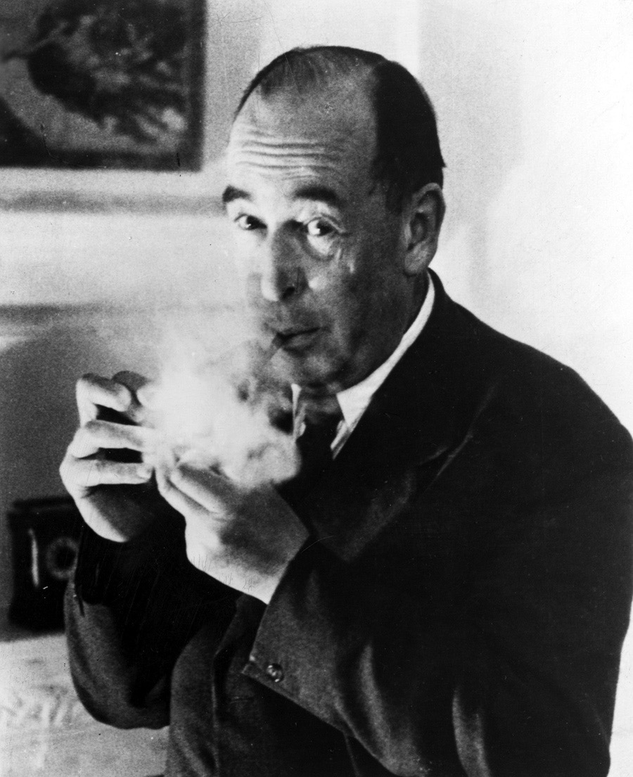 Black and white photograph of C.S. Lewis smoking a pipe, wearing glasses and a tweed jacket
